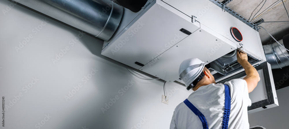 Worker Fixing A Vent